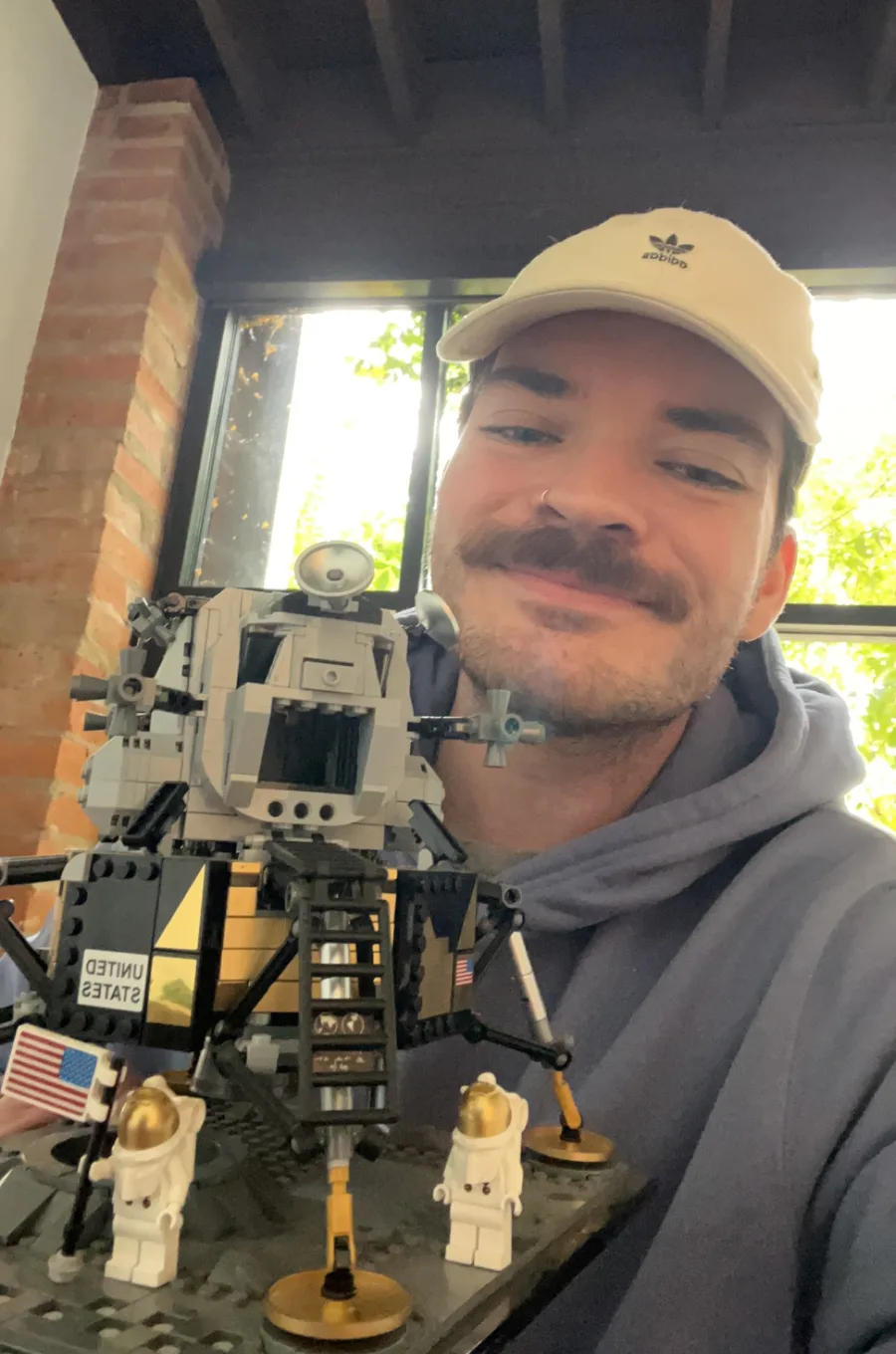 Jack smiling beside a finished LEGO Apollo lunar lander