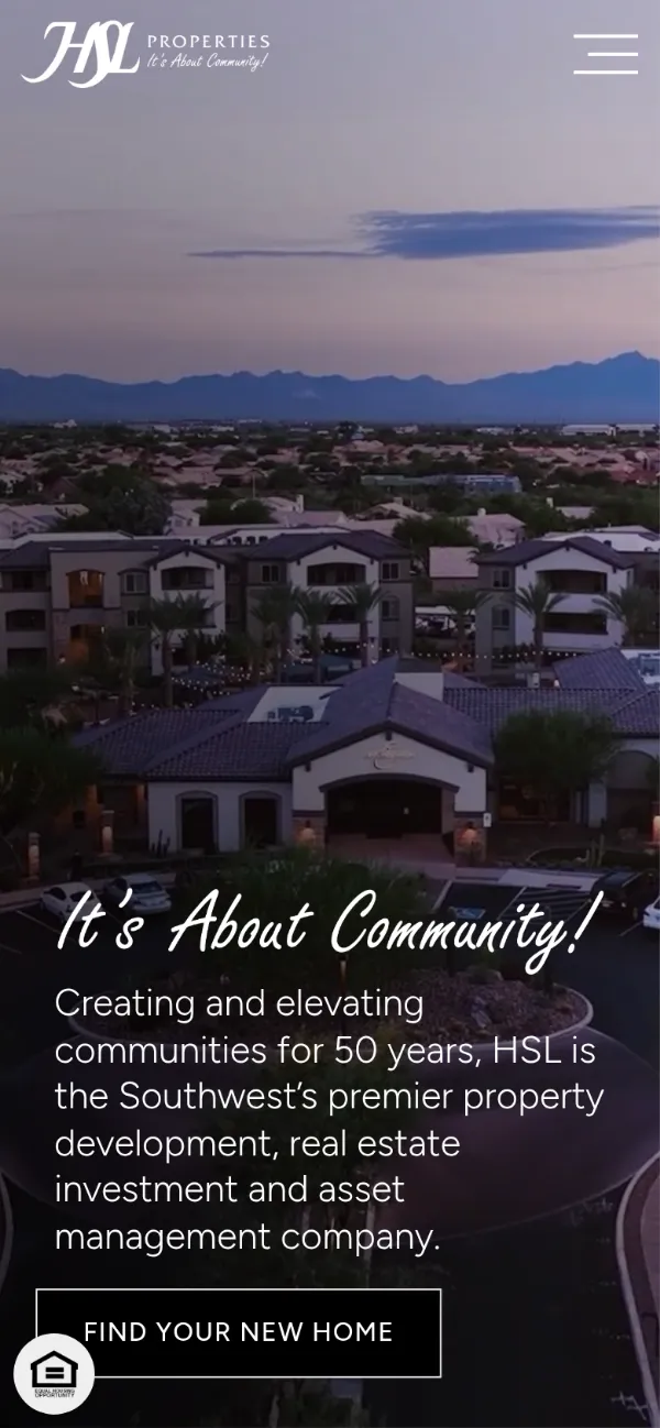 The HSL Properties website on a phone: an aerial of one of its communities at dusk under the headline It’s About Community!