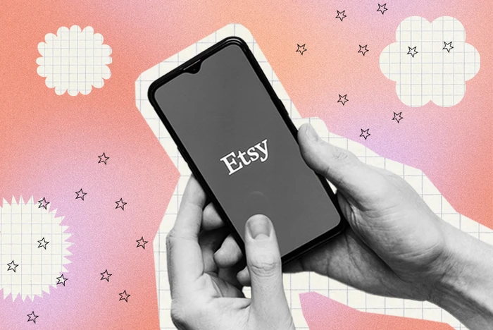 Hands holding a phone with the Etsy logo on screen